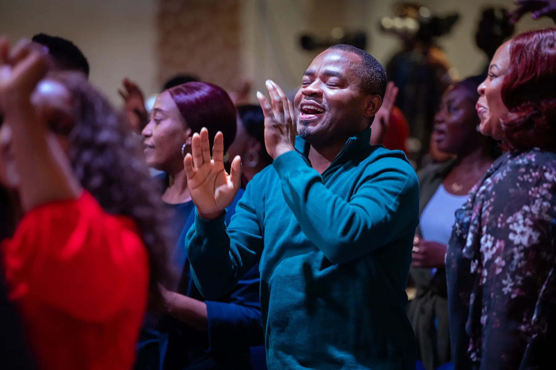 Church members smiling and clapping together