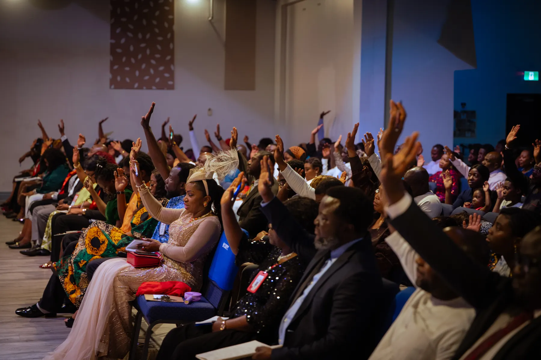 The congregation raising their hands in praise