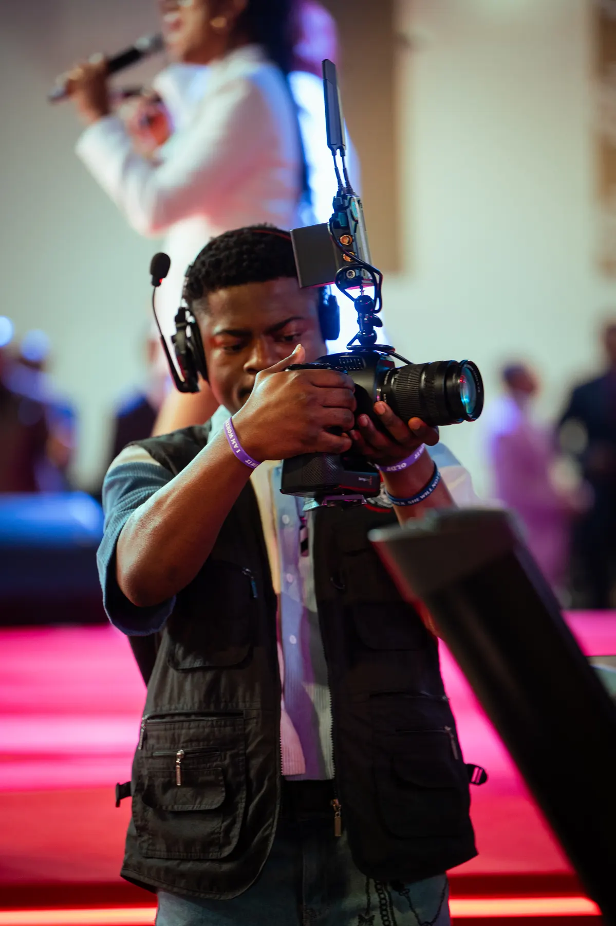 A media volunteer filming the service