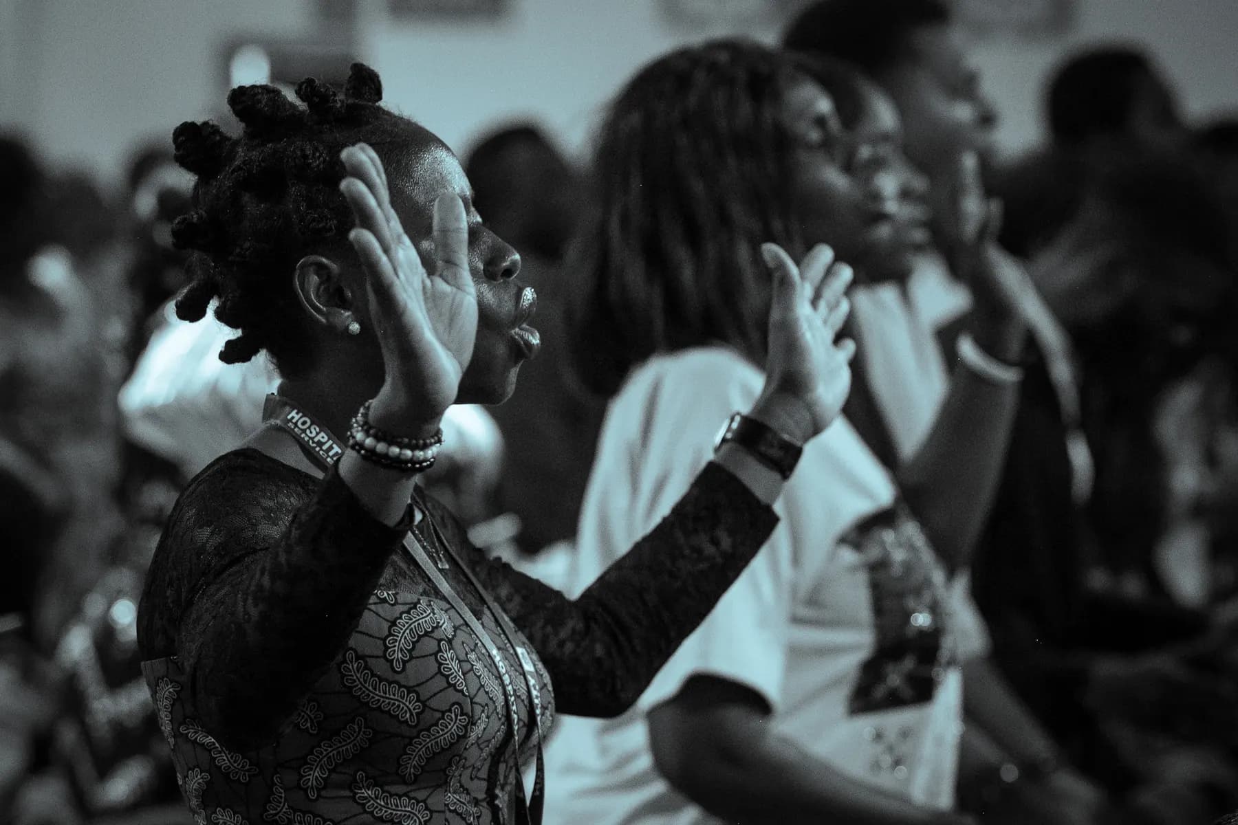 A member praying with hands raised